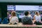 Wimbledon, UK - July 14, 2019: A man and a lady sit in front of outdoor screen at wimbledon before men`s final
