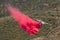 Winchester, CA USA - June 14, 2020: Cal Fire aircraft drops fire retardant on a dry hilltop wildfire near Winchester, California