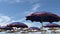 Wind blowing. Beach blue umbrellas at Adriatic sea in Albania,Durres