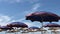 Wind blowing. Beach blue umbrellas at Adriatic sea in Albania,Durres