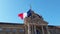 Wind blowing France flag on the mast against blue sky background in front of Palais du Rhin, Place de la Republique, Strasbourg, A