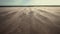 Wind blowing sand over barren dunes