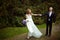 Wind blows away bride\'s dress while she walks along the path hol