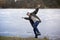 The wind blows away a person and he falls on a barely winter frozen lake on thin ice. accidental drop into water. out of focus