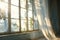 wind blows through the open window in the room. Waving white tulle near the window. Morning sun lighting the room, shadow