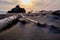 Wind creates ripples in sand trapped between driftwood.  Brookings, Oregon