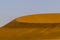 Wind on the crest of a of red dune in the Namib Desert, Sossusvlei, Namibia