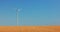 Wind electric turbines in agricultural wheat field in countryside. Windmills