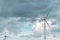 Wind energy generators on the field under stormy dramatic sky. Horizontal background