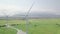 Wind energy turbine on green field and mountain landscape. Aerial view windmill turbine on power station. Alternative