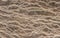 Wind eroded sandstone rock face with wavy pattern ideal for natural textured background