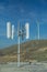 Wind farm: Industrial Eolic installation . Wind turbines towers again cloud blue sky on a wind farm sustainable, renewable energy