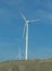 Wind farm: Industrial Eolic installation . Wind turbines towers again cloud blue sky on a wind farm sustainable, renewable energy