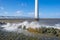 Wind farm in a lake during a storm in sunlight in winter