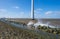 Wind farm in a lake during a storm in sunlight in winter