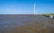 Wind farm in a lake during a storm in sunlight in winter