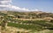 Wind Farm and Olive field with blue sky and clouds at Crete Island, Greece