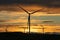 Wind farm silhouette. Wind turbine farm at sunset