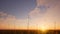 Wind farm sunset on grass