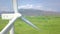 Wind farm turbines drone view. Windmill turbine generating clean renewable energy in green agricultural field aerial