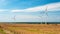 Wind farm in the vicinity of agricultural fields. Windmills generating clean energy. The Baltic Sea in the distance. Darlowo,