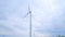 Wind generator against cloudy sky. Wind turbine generating wind power