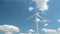 Wind generator on bright cloudy sky background
