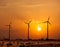 Wind generator turbines sihouettes on sunset