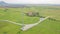 Wind generators on green field on mountain landscape. Aerial view windmill turbine on wind energy station. Renewable