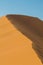 Wind going over sand dune ridge in Namib desert