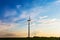 Wind industry in countryside. Wind turbines in field. Sunrise on farmlands