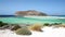 Wind moving the grassland on white sands of Balos beach lagoon on Crete, Greece. Gramvousa island can be seen in the