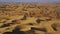 Wind playing on soft rippled surface of Liwa sand dune barkhanes on beautiful sunset light, UAE