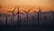 Wind Power Air Breeze Wind Generator turbines field in California at sunset time. Green energy concept.