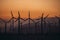 Wind Power Air Breeze Wind Generator turbines field in California at sunset time. Green energy concept.