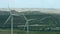 Wind power generation, windmills rotating, energy saving. Mountain landscape