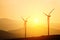 Wind power generators on the background of silhouettes of mountain peaks. Simplicity and minimal lines. Beautiful landscape of the