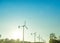 Wind power installation in sunny day with wind turbine blue sky.