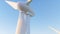 Wind power plant at sunset under clear blue sky in field