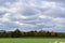 wind power plants at a farm with autumn trees