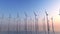 Wind power plants in Sea at beautiful Sunrise