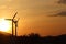 Wind power station in sunset. Romantic evening and modern technologies of ecologically clean electricity. Protection of the enviro