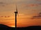 Wind power station in sunset. Romantic evening and modern technologies of ecologically clean electricity. Protection of the enviro