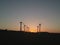 Wind power station in the sunset. Rotating blades of energy generators. Ecologically clean electricity. Modern technologies for t