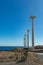 Wind power stations. A row of turbines near the seashore. Wind farm eco field. Eolic park with blue sky in background. Green,