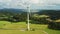 Wind rotates blades of modern windmill standing near road