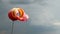 Wind sock with rainy stormy clouds background. Red and yellow
