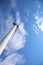 Wind turbine against blue sky, low angle view. Alternative energy source