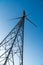 Wind turbine against a clear blue sky. Theme of renewable energy clean power generation and sustainable energy concepts.