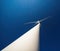 Wind turbine against deep blue sky, view up with dramatic perspective